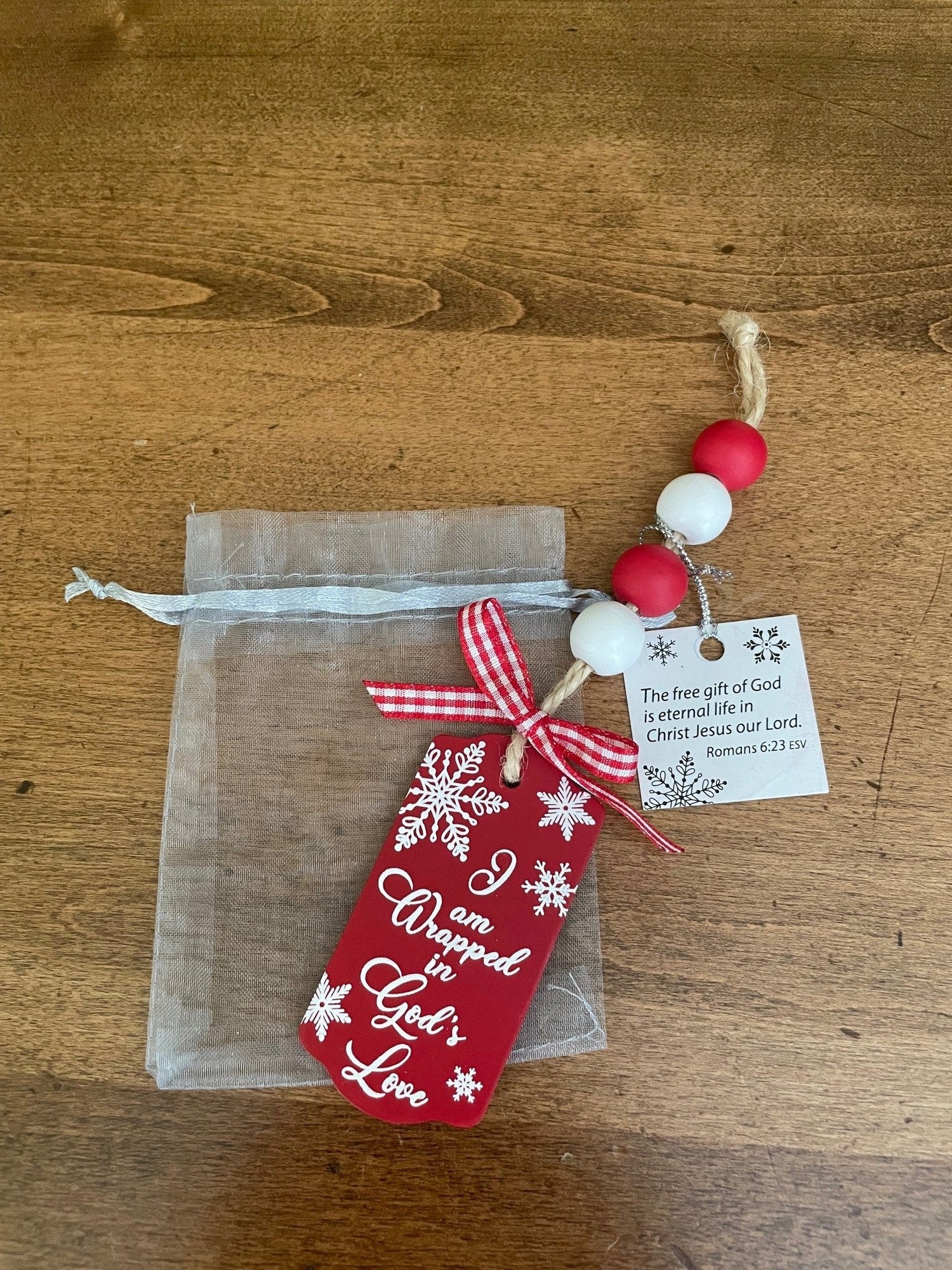 Wrapped in God's Love Wooden Ornament in Organza Bag with Tag