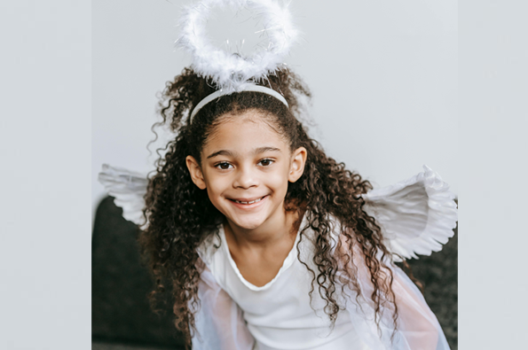 Girl in angel's costume for a church Christmas program